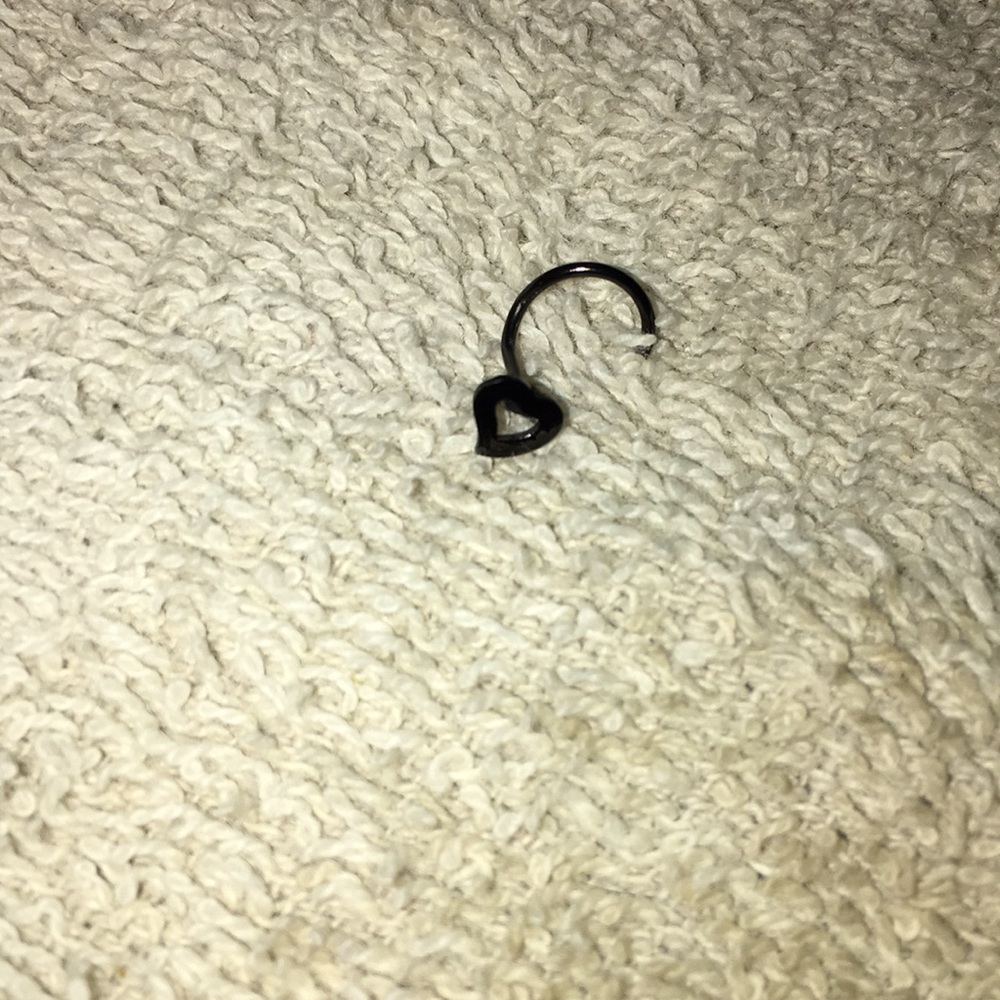 Black corkscrew nose stud.